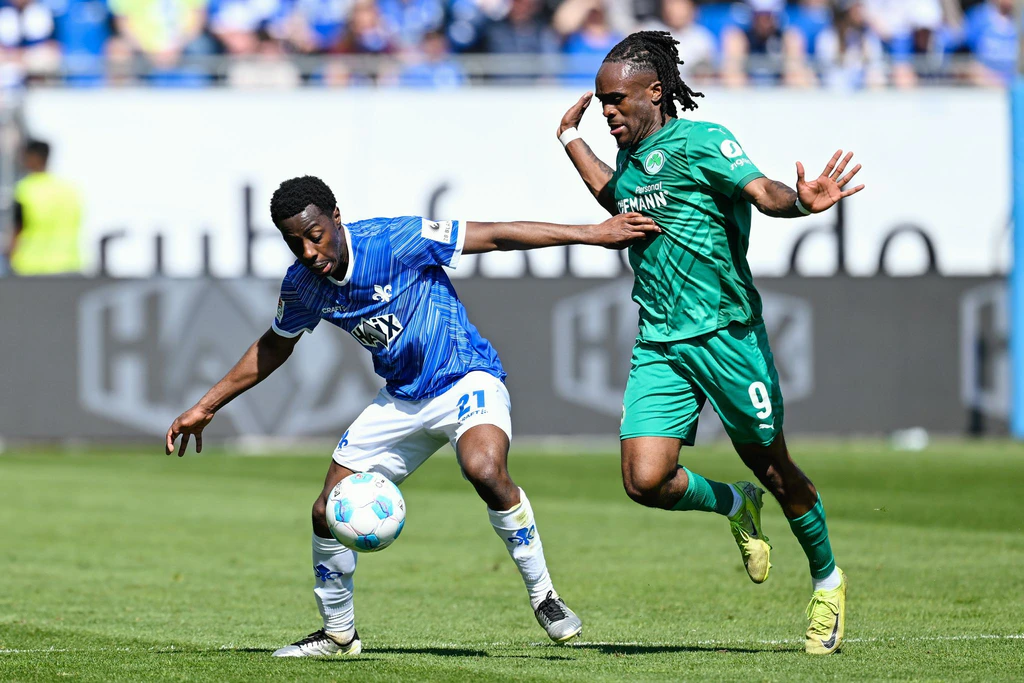 Der SV Darmstadt 98 mit Merveille Papela (l) bezwang die SpVgg Greuther Fürth mit Noel Futkeu. — © Uwe Anspach/dpa